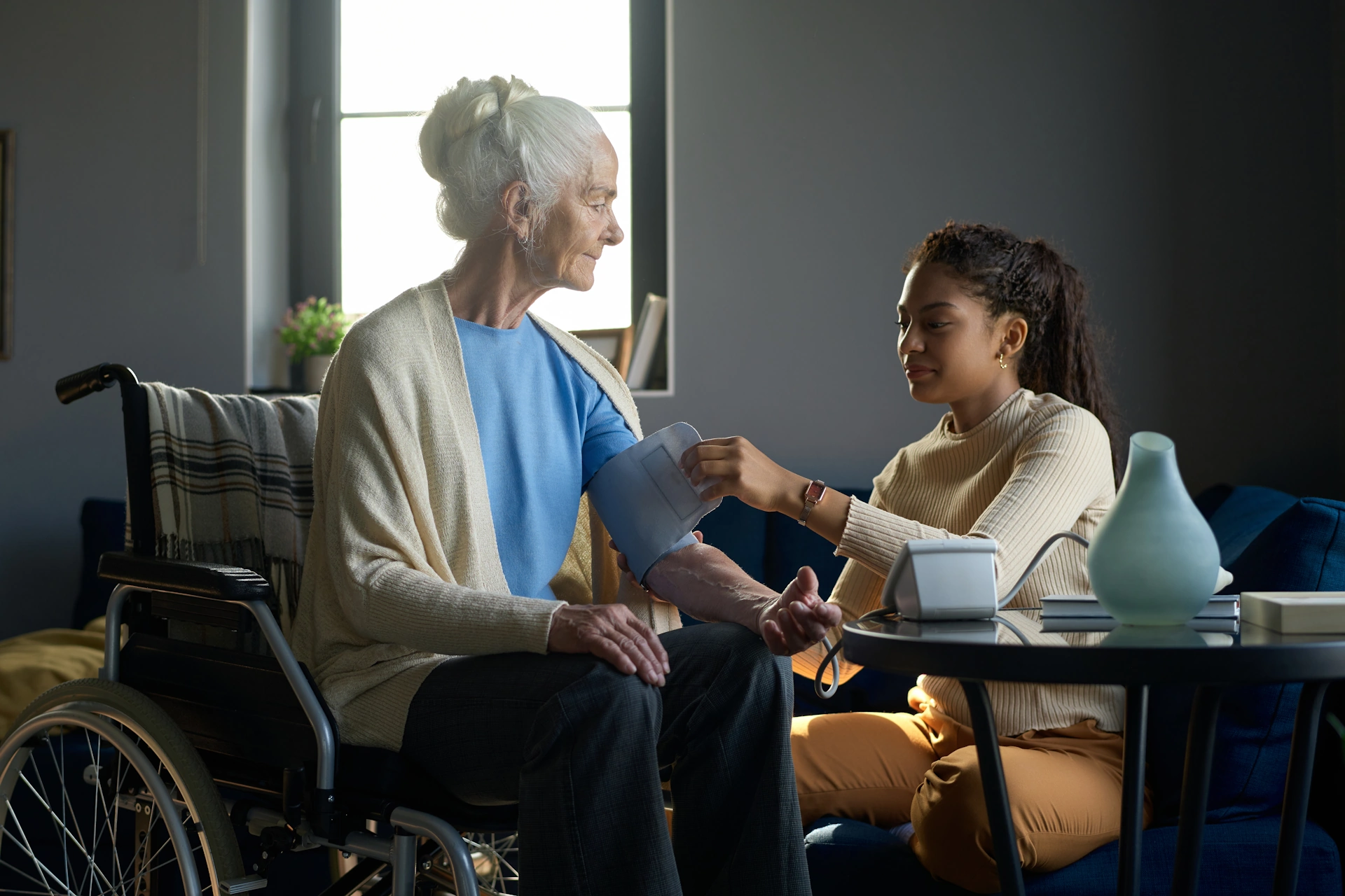 in-home-care-Frontenac-MO-2 caregiver prepares elder female to have her blood pressure taken