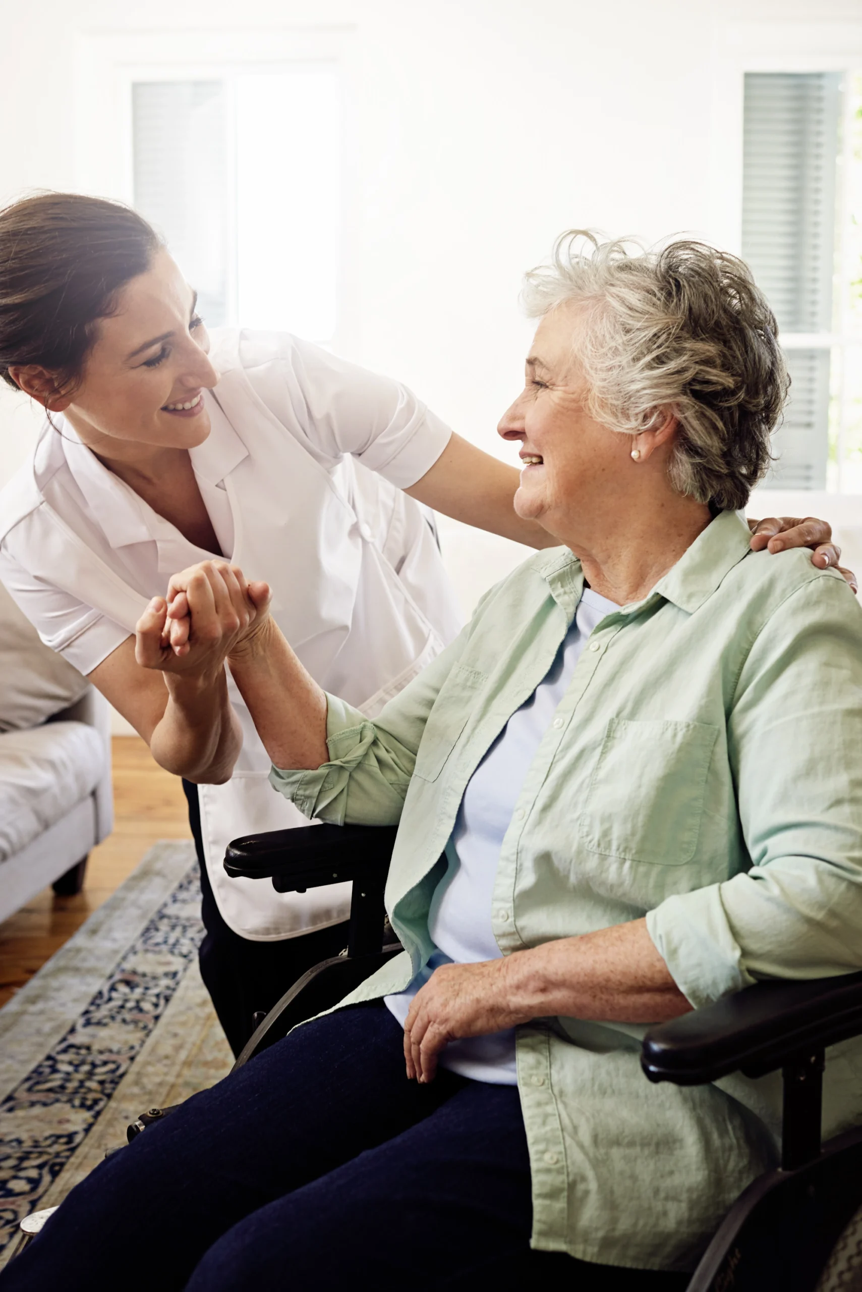 in-home-care-Frontenac-MO-3 elderly woman in wheenchair holds hands with caregiver